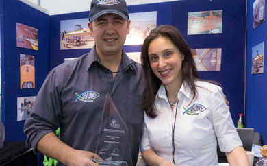Eleni and Nick displaying the SAV EFF and Innovation Award at the Melbourne Boat Show up close